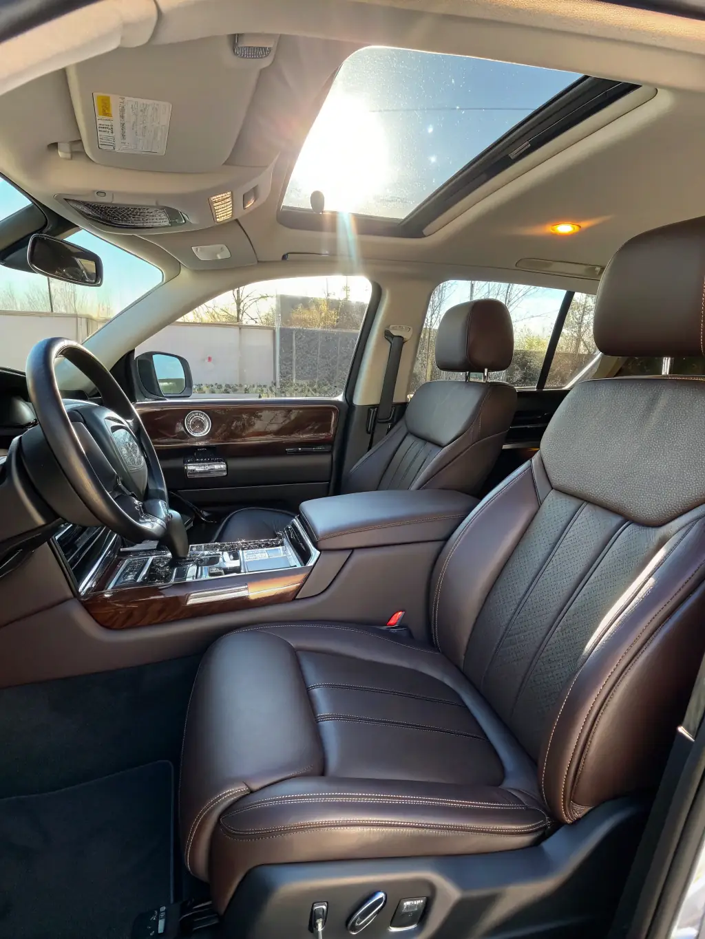 A detailed shot of a car's interior, showcasing spotless seats, a clean dashboard, and pristine carpets after JK Car Detailing's Interior Detailing service. The image should convey a sense of freshness and cleanliness.